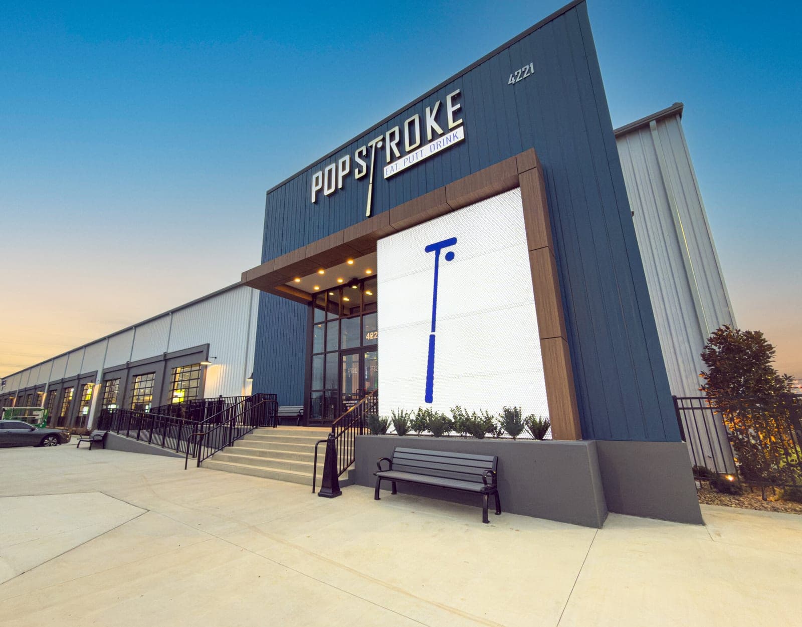 PopStroke Nashville facade at dusk
