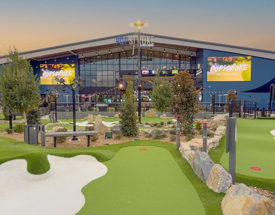 The outdoor course at dusk in front of PopStroke Nashville